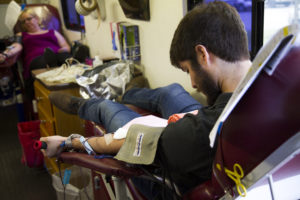 Jacob Patterson, Supply Chain Analyst, and Sara White, EDI Support Analyst, give blood.